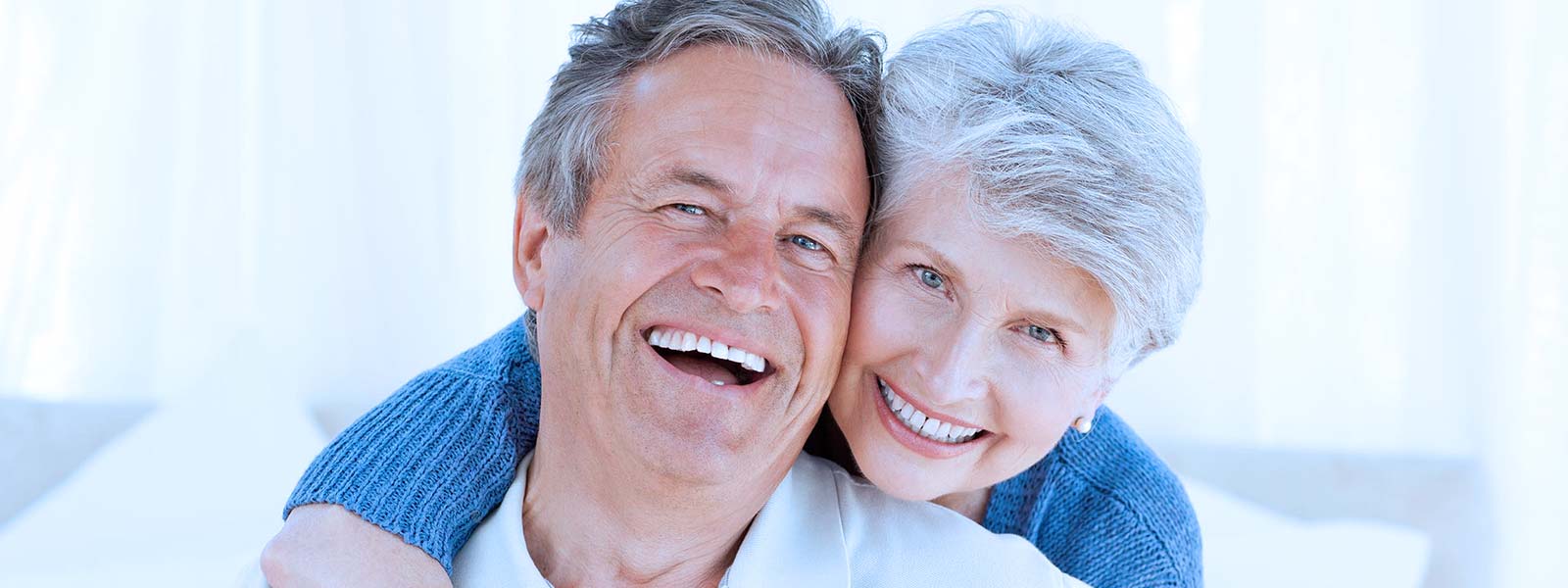 happy senior couple after their dentures