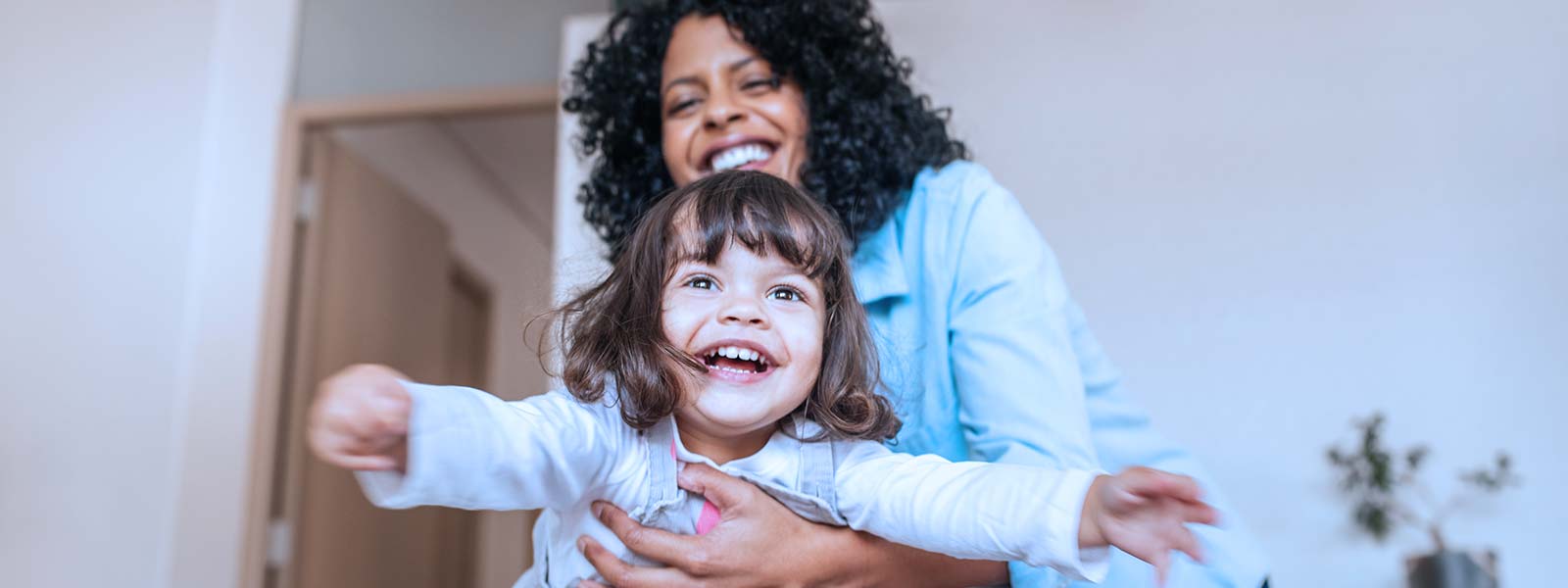 Mother and daughter playing after pediatric dentistry