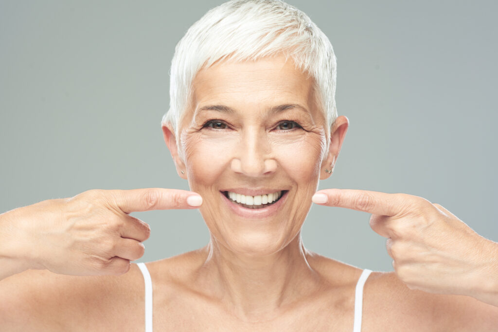 Beautiful Caucasian smiling senior woman with short grey hair